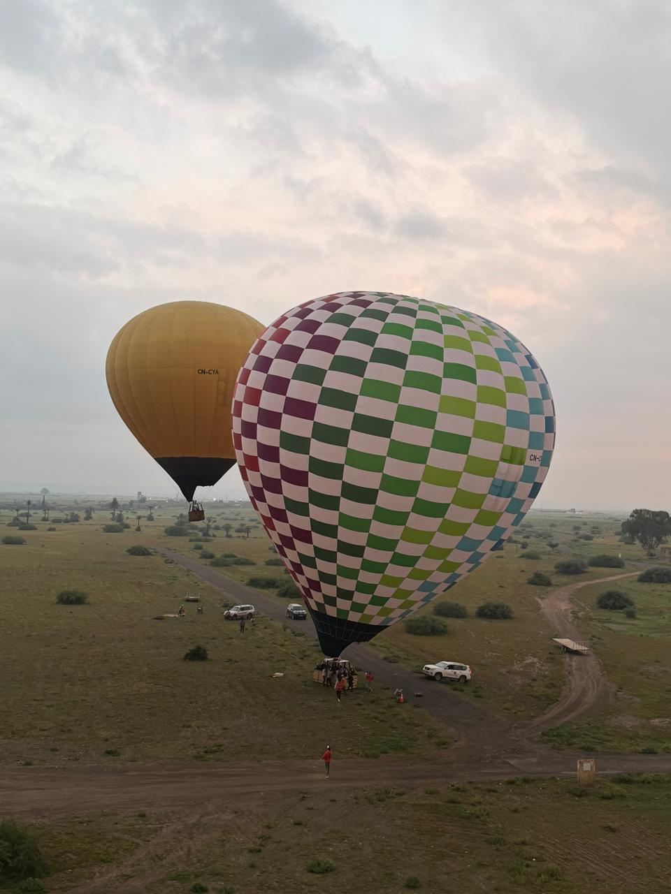 Hot air balloon floating serenely above Marrakech countryside